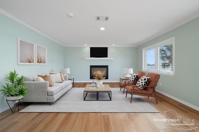 living room with crown molding and light hardwood / wood-style floors