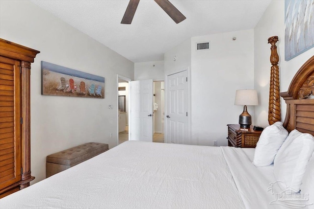 bedroom with a textured ceiling and ceiling fan