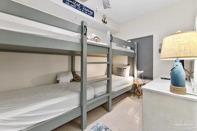 tiled bedroom featuring ceiling fan