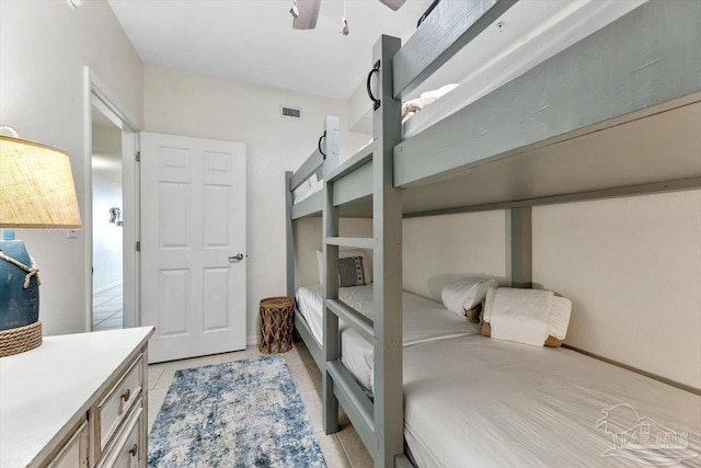 bedroom featuring light tile patterned floors and ceiling fan