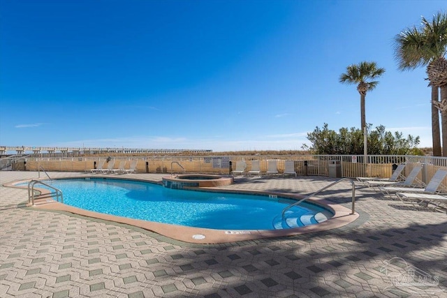 view of pool with a patio area and a community hot tub