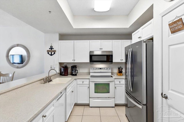 kitchen with stainless steel appliances, white cabinetry, sink, and light tile patterned flooring