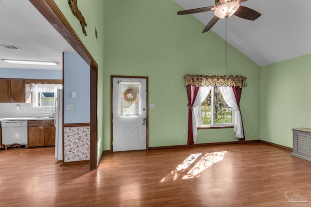 foyer entrance featuring ceiling fan, sink, light hardwood / wood-style floors, and high vaulted ceiling