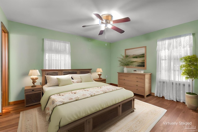 bedroom with hardwood / wood-style flooring and ceiling fan