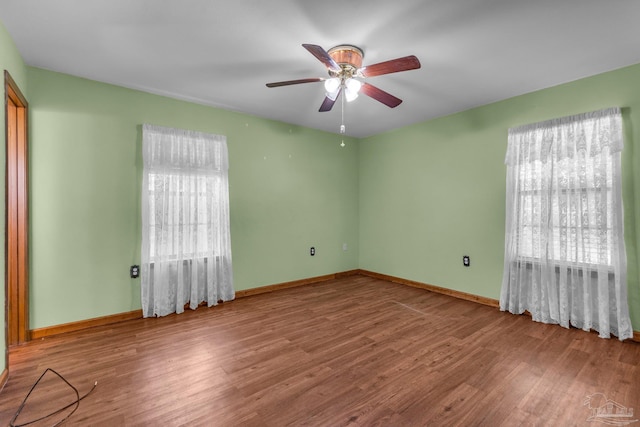 empty room with ceiling fan and wood-type flooring