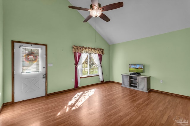 unfurnished living room with light wood-type flooring, high vaulted ceiling, and ceiling fan