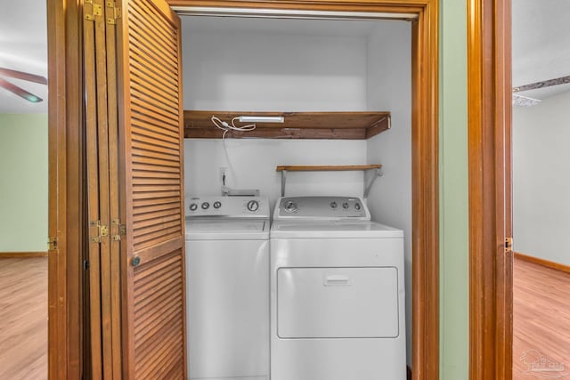 clothes washing area with light wood-type flooring and washing machine and dryer