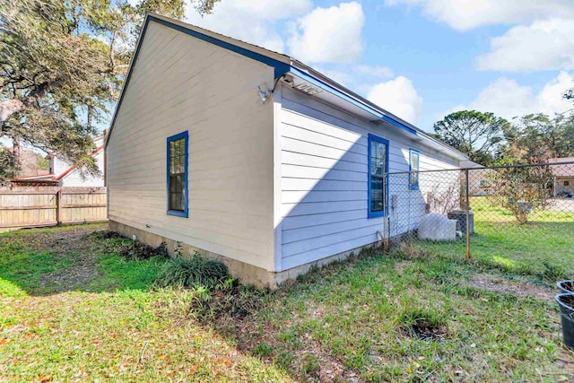 view of side of home featuring a yard