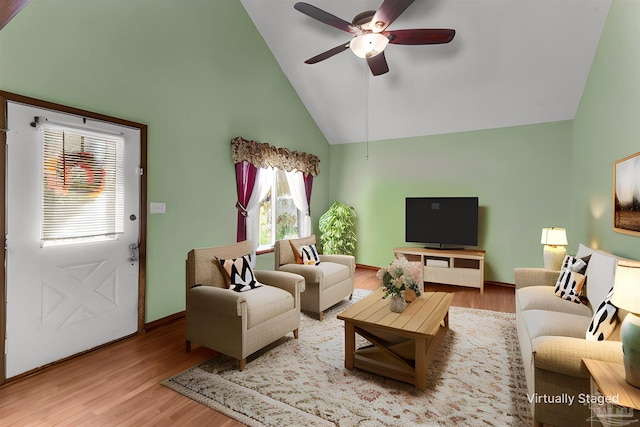 living room with ceiling fan, high vaulted ceiling, and wood-type flooring