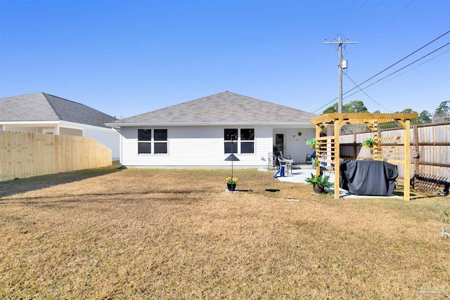 rear view of house with a patio, a lawn, and a pergola