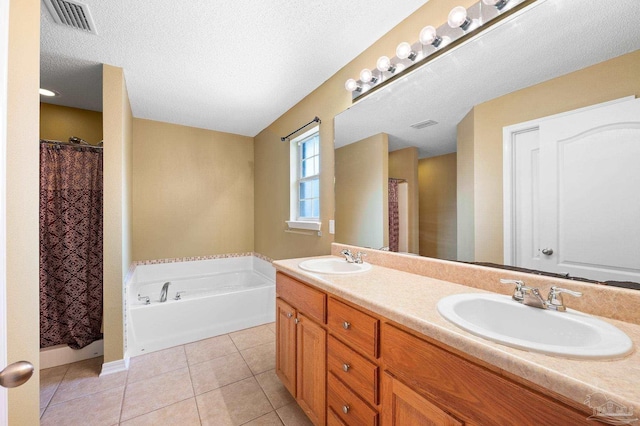 full bathroom with tile patterned flooring, a textured ceiling, visible vents, and a sink