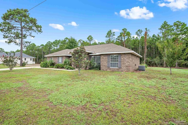 view of front of home with a front lawn and central air condition unit