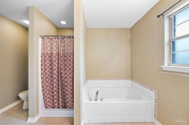 bathroom featuring curtained shower, toilet, a garden tub, tile patterned floors, and a textured ceiling