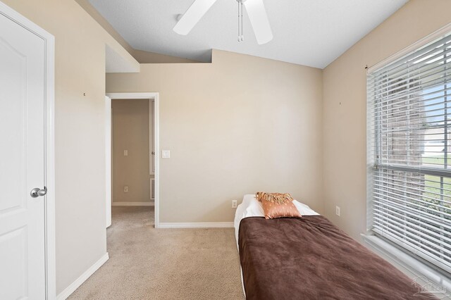 bedroom with a textured ceiling, ceiling fan, and carpet flooring