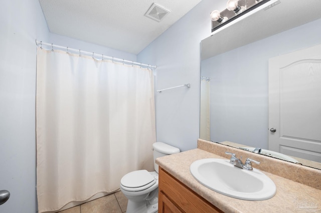 full bathroom featuring visible vents, toilet, vanity, and tile patterned flooring