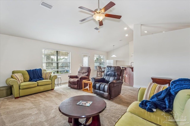 living room with sink, vaulted ceiling, light colored carpet, and ceiling fan