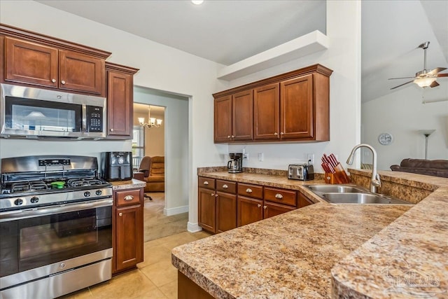 kitchen featuring lofted ceiling, sink, light tile patterned floors, appliances with stainless steel finishes, and ceiling fan with notable chandelier