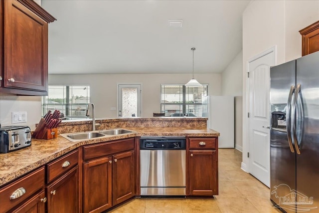 kitchen featuring pendant lighting, sink, light tile patterned floors, appliances with stainless steel finishes, and vaulted ceiling