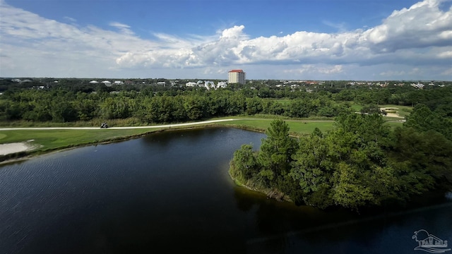drone / aerial view of a large body of water, a tree filled landscape, and a golf course