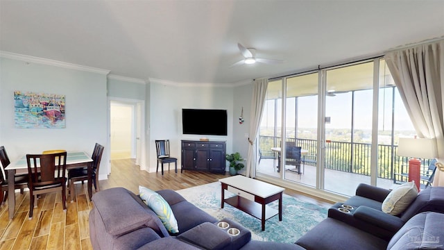 living room featuring ceiling fan, light wood finished floors, floor to ceiling windows, and ornamental molding