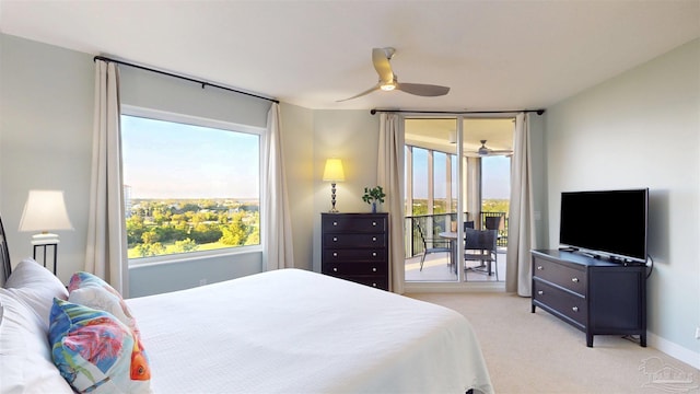 bedroom featuring access to outside, multiple windows, light colored carpet, and a ceiling fan