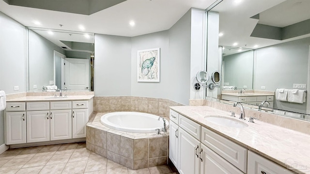 full bathroom with a bath, tile patterned floors, two vanities, and recessed lighting