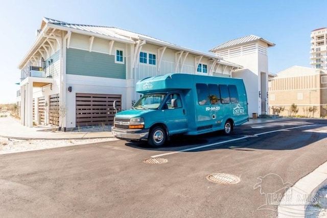 view of parking / parking lot featuring an attached garage