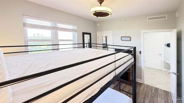 unfurnished bedroom featuring wood finished floors and baseboards
