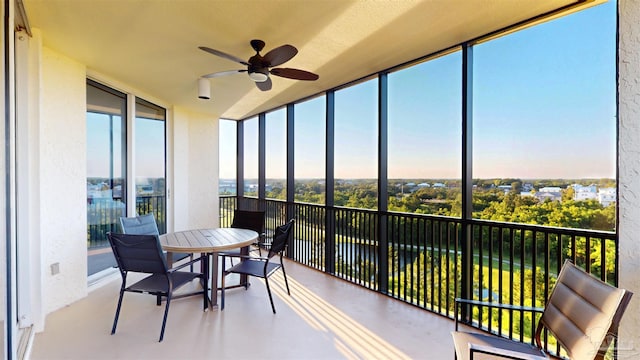 sunroom with expansive windows and a water view
