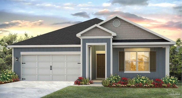 view of front of house with a yard and a garage