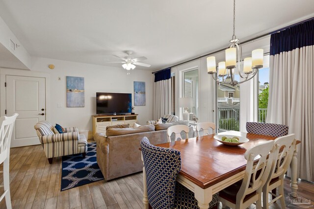 dining space featuring an inviting chandelier and light hardwood / wood-style floors