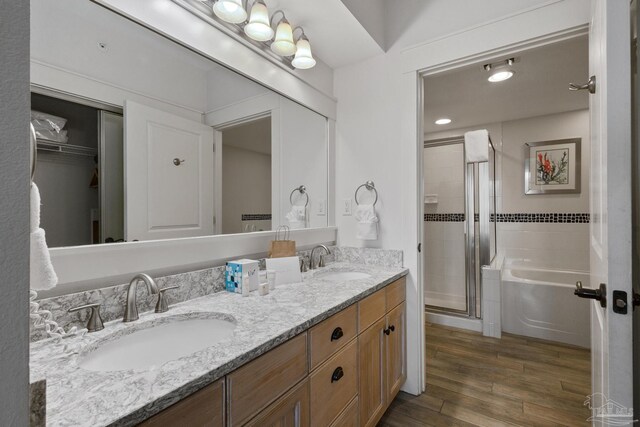 bathroom featuring wood-type flooring, toilet, and separate shower and tub