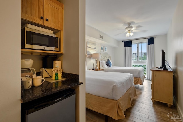 bedroom with ceiling fan and wood-type flooring