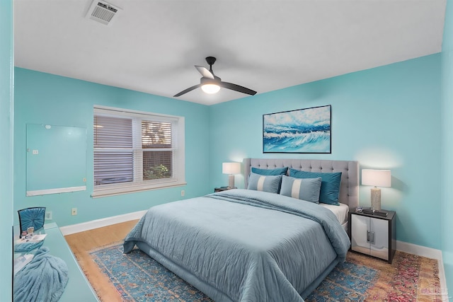 bedroom with wood-type flooring and ceiling fan