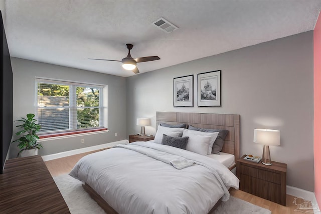 bedroom with ceiling fan and light hardwood / wood-style flooring