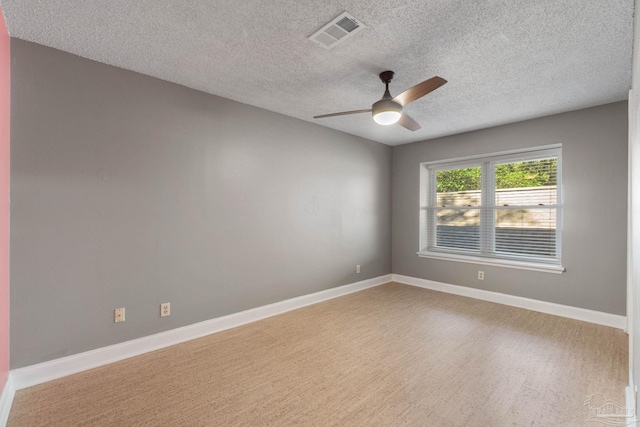 spare room featuring ceiling fan, a textured ceiling, and light hardwood / wood-style flooring