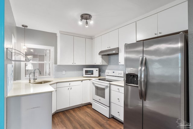 kitchen featuring white cabinetry, sink, dark wood-type flooring, and white appliances