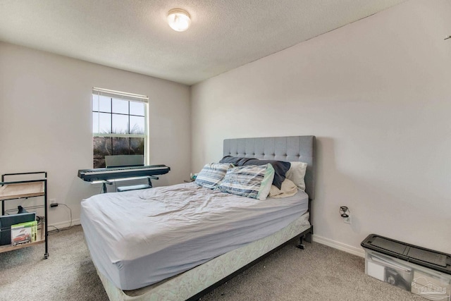 carpeted bedroom with baseboards and a textured ceiling