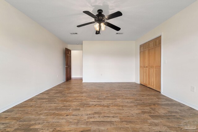 spare room with ceiling fan and hardwood / wood-style floors