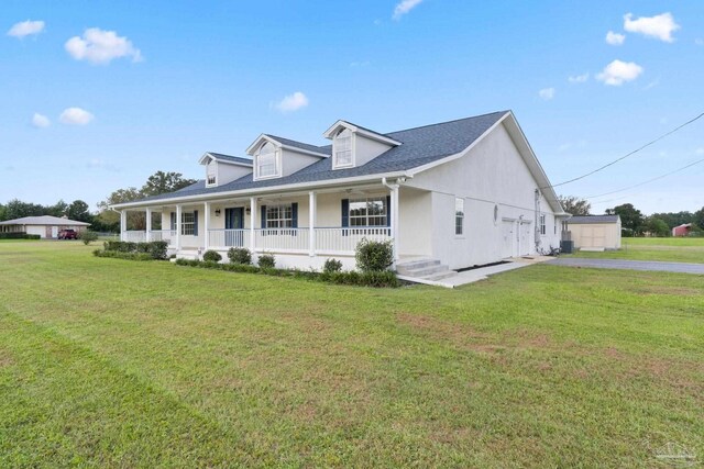 view of front of home featuring a storage shed, a front lawn, and a porch