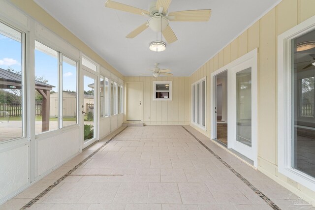 sunroom / solarium with ceiling fan and a healthy amount of sunlight