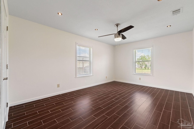 unfurnished room featuring ceiling fan, plenty of natural light, and dark hardwood / wood-style floors