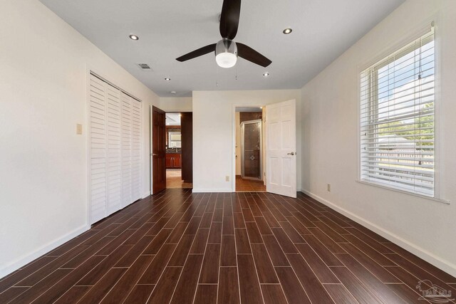 unfurnished bedroom featuring a closet, ceiling fan, and dark hardwood / wood-style floors