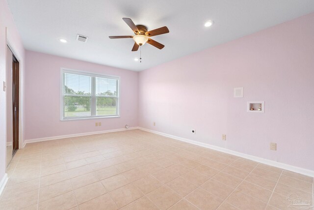 tiled empty room featuring ceiling fan