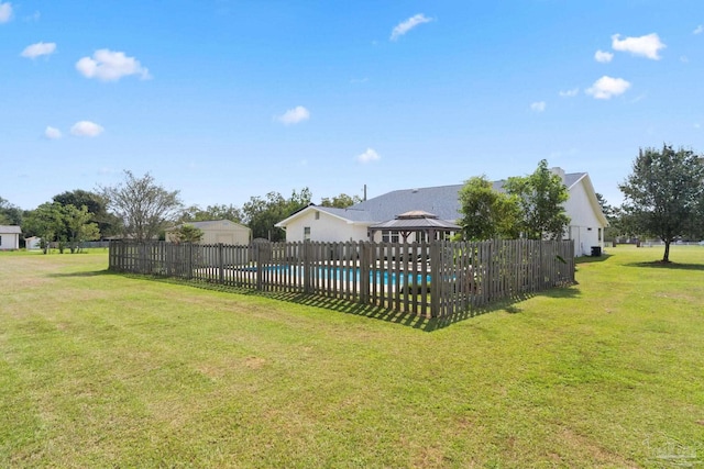 view of yard with a fenced in pool and a gazebo