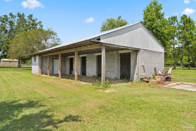 view of outbuilding featuring a lawn