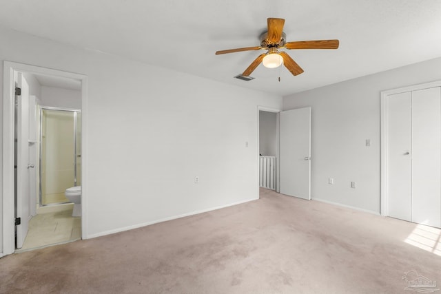 unfurnished bedroom with carpet floors, ensuite bath, a ceiling fan, and baseboards