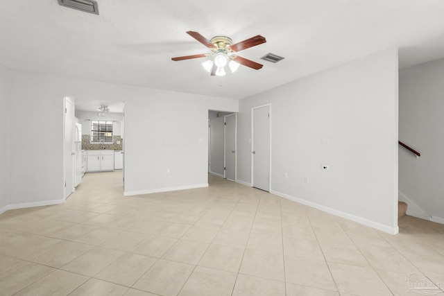 interior space with stairs, ceiling fan, visible vents, and baseboards