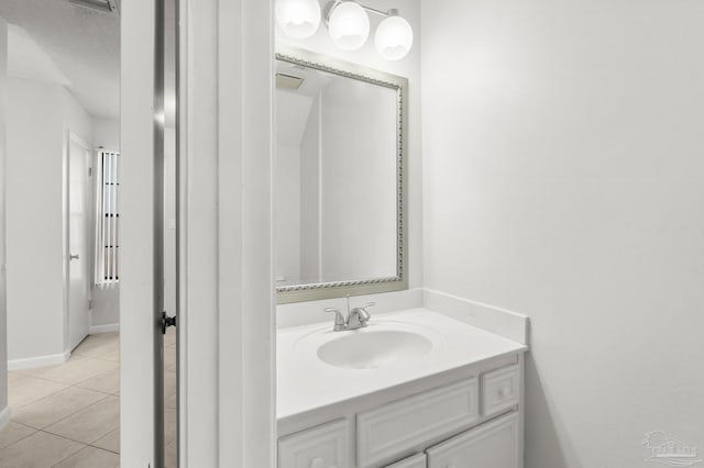 bathroom with tile patterned flooring and vanity