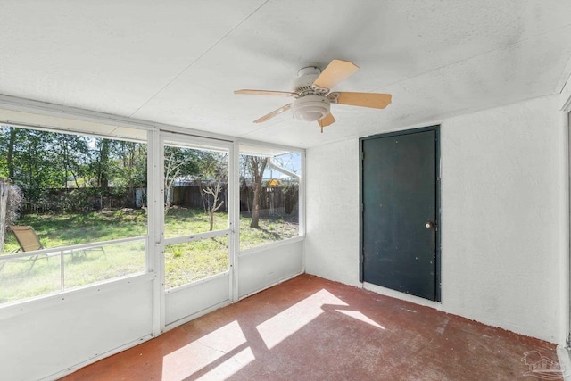 unfurnished sunroom with a ceiling fan